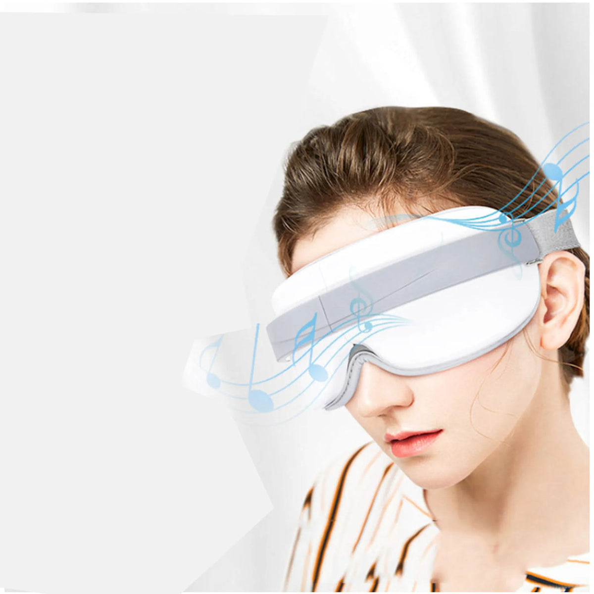 Woman relaxing with the white Eye Lux eye massager over her eyes while music plays