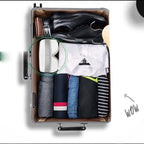 Eye Lux eye massager folded in half and packed in a suitcase with clothes and shoes