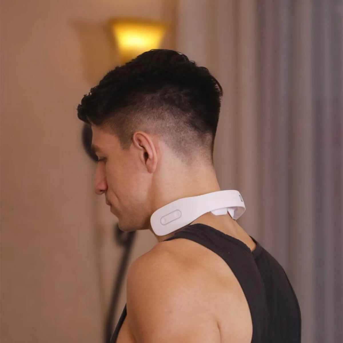 Man wearing the white K3 neck massager around the back of his neck