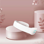 White K3 neck massager resting on a pink stand with soft pink decor