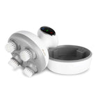Armona massager tipped on its side with brush heads attached, next to its charging base