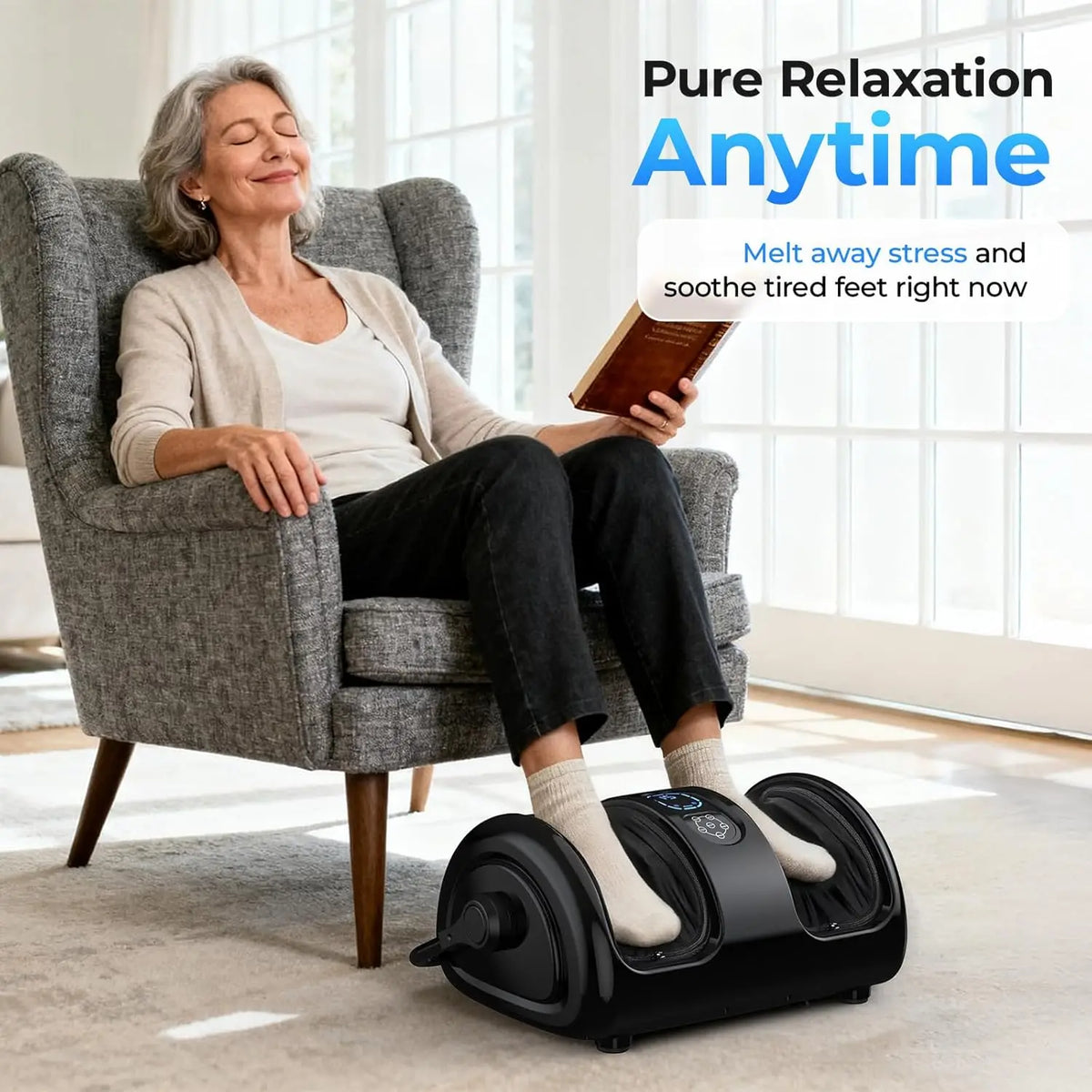 Smiling older woman reading in an armchair with her feet in the massager, captioned pure relaxation anytime