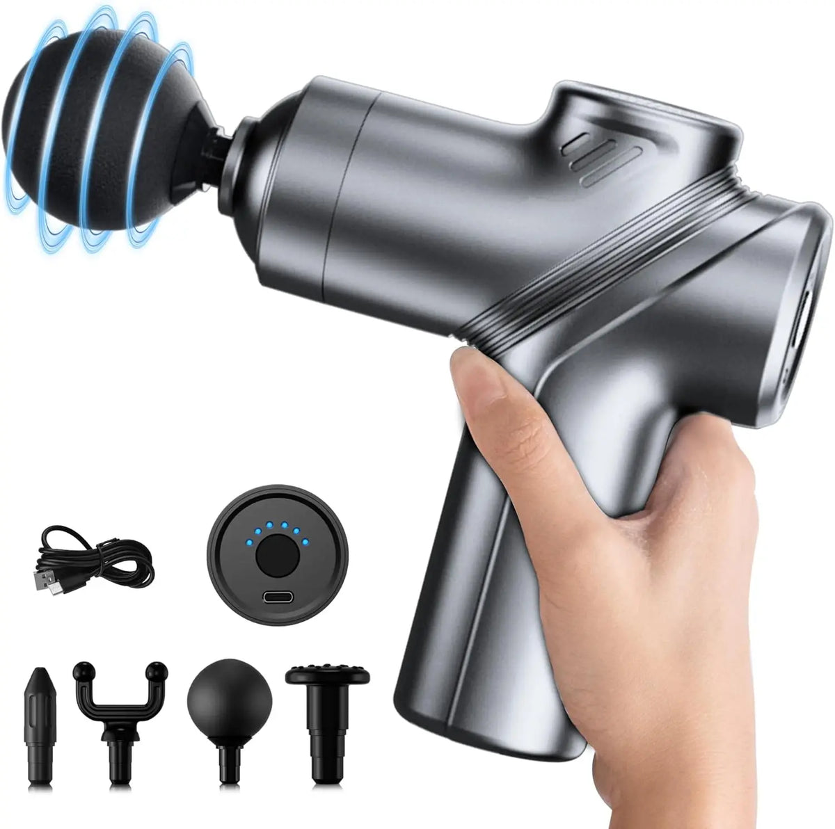 Hand holding the gray mini massage gun, shown with its charging cable, case and four massage heads