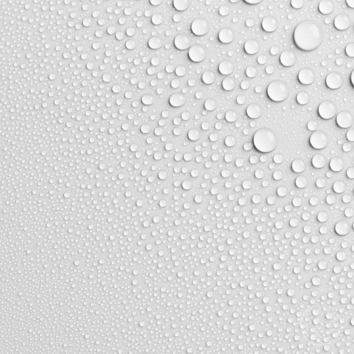 Fine water droplets on a white surface, showing the light mist of the Innatus pillow spray