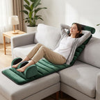 Woman relaxing on the green mat on a sofa with her feet in the foot massager