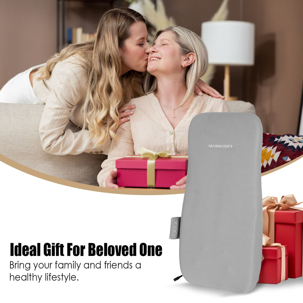 Two women hugging beside the back cushion and wrapped gifts