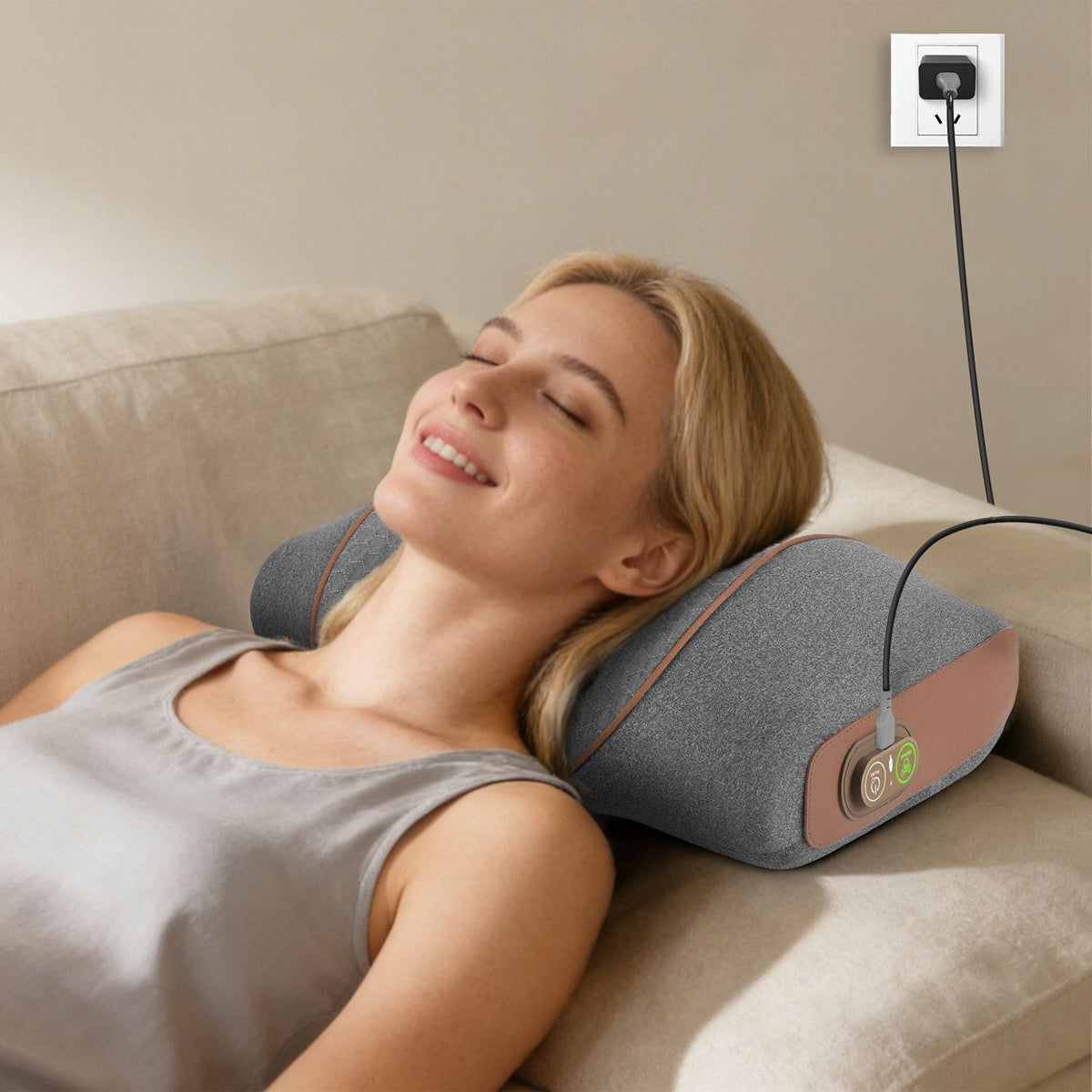 Woman resting on the neck pillow in bed with the cable plugged into the wall
