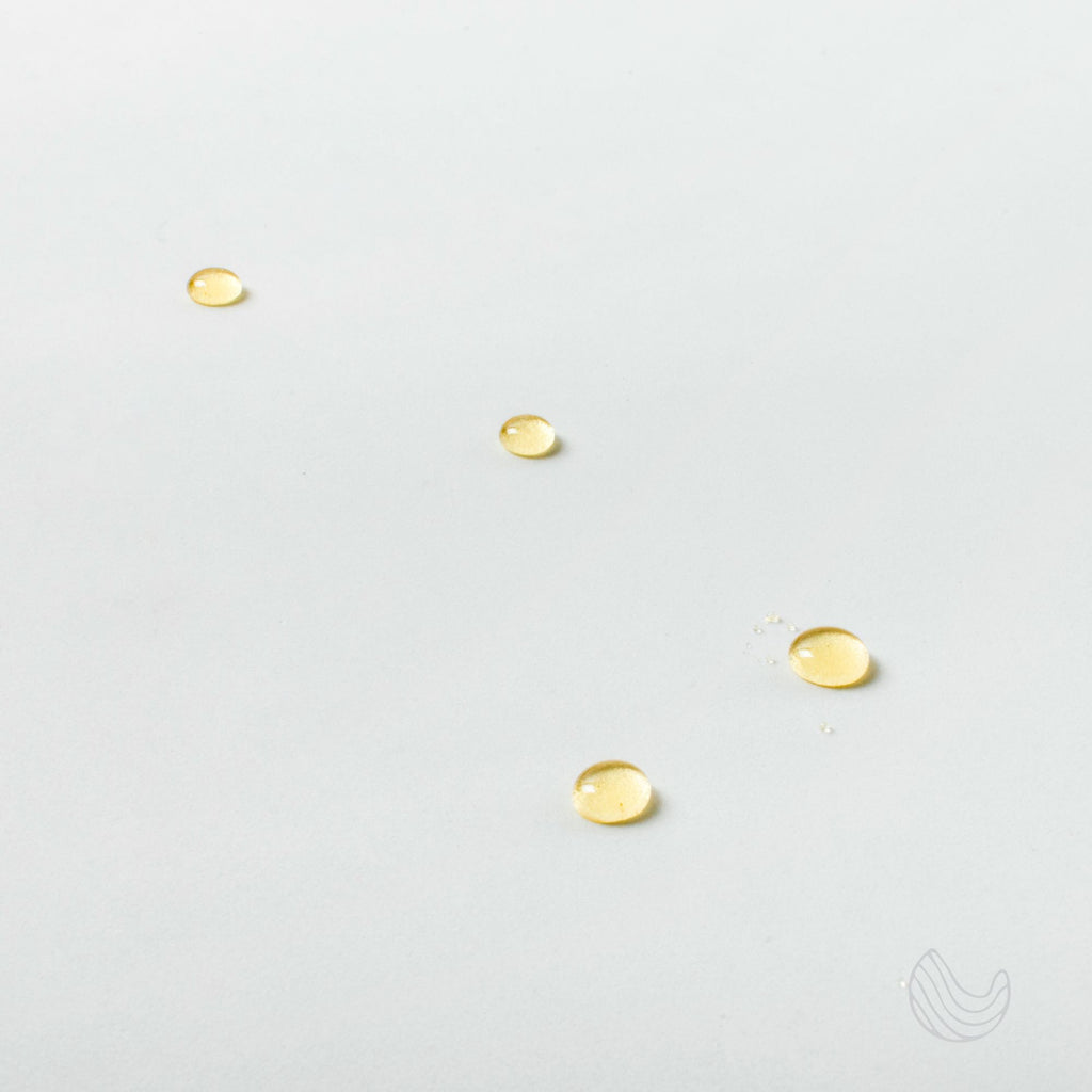 Drops of Innatus Dream essential oil on a white surface