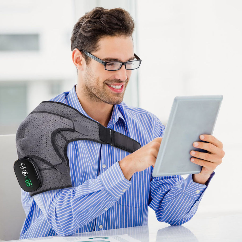 Man reading a tablet while wearing the gray shoulder wrap