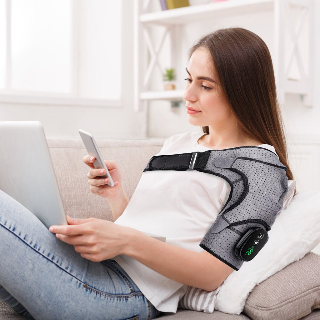 Woman using her phone on a sofa while wearing the shoulder wrap